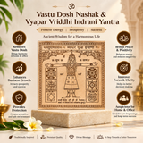 A decorative Vastu Dosh Nashak & Vyapar Vriddhi Indrani Yantra plaque displayed on a stone pedestal, surrounded by promotional text and icons in Hindi about its benefits, with candles, flowers, and a softly lit interior background.