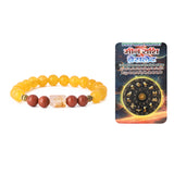 Yellow beaded bracelet with brown and red stones on a white background, featuring a card with astrological design.
